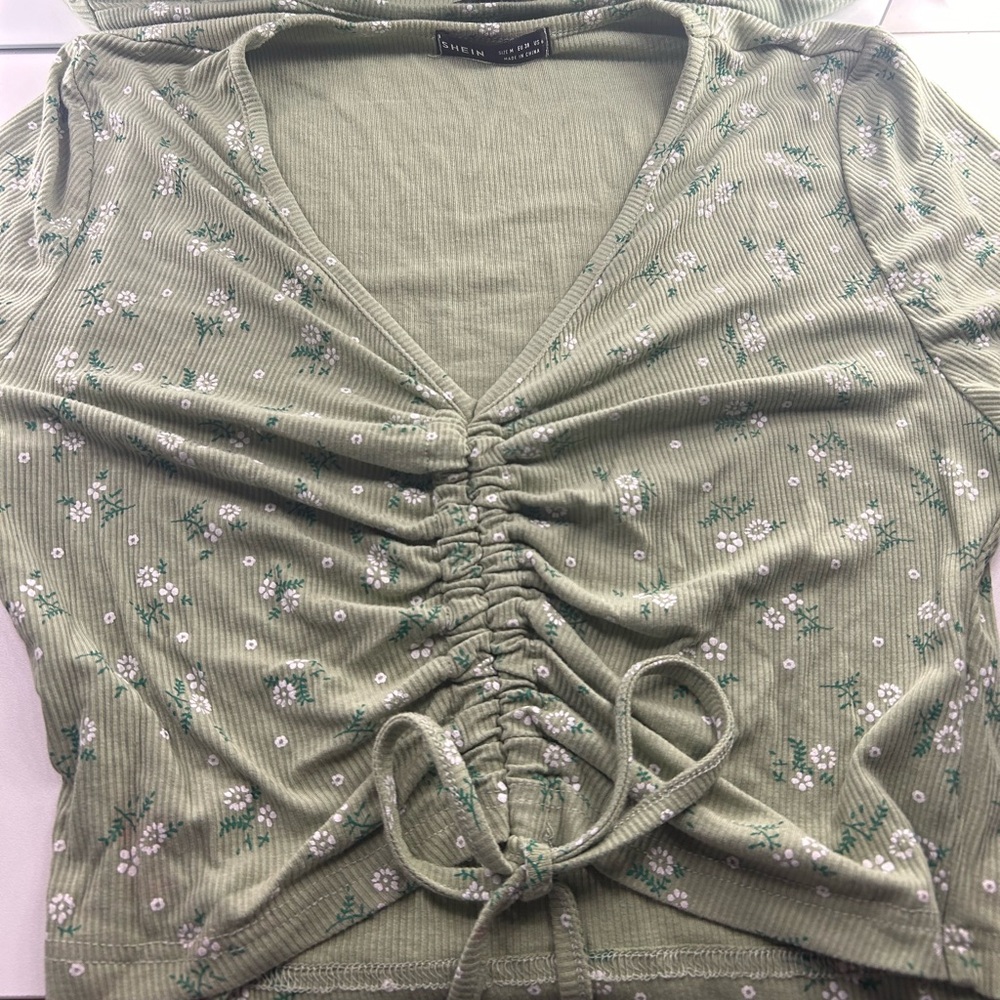 Sage Green flower T-Shirt with a long v neck.